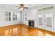 Bright living room with hardwood floors, a cozy fireplace, and double doors to the backyard at 2920 W El Prado Blvd # 4, Tampa, FL 33629