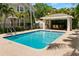 Beautiful pool area with crystal clear water and a covered outdoor seating space at 2920 W El Prado Blvd # 4, Tampa, FL 33629