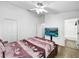 Bedroom featuring mounted television, ceiling fan and closet at 30132 Wellesley Way, Wesley Chapel, FL 33543