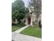 Inviting home exterior with a red door, well-maintained landscaping, and a clear walkway leading to the entrance at 30132 Wellesley Way, Wesley Chapel, FL 33543