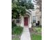 Charming home featuring a red front door, lush landscaping, and a welcoming walkway leading to the entrance at 30132 Wellesley Way, Wesley Chapel, FL 33543