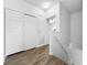 Hallway features wood floors and ample closet space for storage at 30132 Wellesley Way, Wesley Chapel, FL 33543