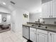 Spacious kitchen featuring stainless steel dishwasher and view to the Gathering room at 30132 Wellesley Way, Wesley Chapel, FL 33543