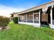 Exterior view of a screened-in porch offering an inviting outdoor living space, blending indoor comfort with outdoor views at 30132 Wellesley Way, Wesley Chapel, FL 33543