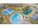 Aerial view of community pool, tennis courts, and playground at 3138 Clover Blossom Cir, Land O Lakes, FL 34638