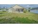 Spacious backyard featuring a shed, screened patio, and well-maintained lawn at 3138 Clover Blossom Cir, Land O Lakes, FL 34638
