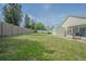 Large backyard with a fence, shed, and screened patio at 3138 Clover Blossom Cir, Land O Lakes, FL 34638