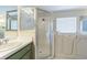 Bathroom with an enclosed shower and walk-in tub with a window at 3138 Clover Blossom Cir, Land O Lakes, FL 34638