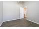 Neutral bedroom with hardwood floors and white door that leads to bathroom at 3138 Clover Blossom Cir, Land O Lakes, FL 34638