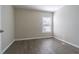 Neutral bedroom featuring hardwood floors, a window, and fresh paint at 3138 Clover Blossom Cir, Land O Lakes, FL 34638