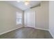 Neutral bedroom featuring hardwood floors, a window, ceiling fan and closet at 3138 Clover Blossom Cir, Land O Lakes, FL 34638