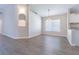 Inviting dining area showcasing wood-look floors, a modern chandelier, and seamless flow to the kitchen at 3138 Clover Blossom Cir, Land O Lakes, FL 34638