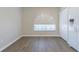 Bright empty room features wood floors, an arched window, and a refrigerator at 3138 Clover Blossom Cir, Land O Lakes, FL 34638