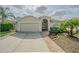 Charming single-story home featuring a well-manicured lawn, brick walkway, and attached two-car garage at 3138 Clover Blossom Cir, Land O Lakes, FL 34638