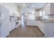 A bright kitchen features stainless steel appliances, white cabinets, granite countertops, and modern flooring at 3138 Clover Blossom Cir, Land O Lakes, FL 34638