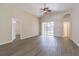 Bright living room with high ceilings, wood floors, and sliding glass doors to the patio at 3138 Clover Blossom Cir, Land O Lakes, FL 34638