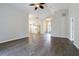 Open living area featuring wood-look flooring, a ceiling fan, and ample natural light throughout the home at 3138 Clover Blossom Cir, Land O Lakes, FL 34638