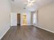 Spacious main bedroom features vaulted ceiling, wood-look floors, ensuite bath, and ample natural light at 3138 Clover Blossom Cir, Land O Lakes, FL 34638