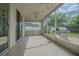 Spacious screened patio with tile flooring, ceiling fans, and a grill at 3138 Clover Blossom Cir, Land O Lakes, FL 34638