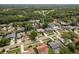 An aerial view of a residential neighborhood with mature trees, manicured lawns, and well-maintained homes at 3388 Tarpon Woods Blvd, Palm Harbor, FL 34685