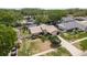 Aerial view of a well maintained home with a manicured front lawn, a long driveway, and mature trees at 3388 Tarpon Woods Blvd, Palm Harbor, FL 34685