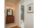Well-lit bathroom with wood vanity, mirror, and shower for convenience and style at 3388 Tarpon Woods Blvd, Palm Harbor, FL 34685