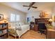 Bedroom featuring a desk and chair, with a ceiling fan and a window with white shutters at 3388 Tarpon Woods Blvd, Palm Harbor, FL 34685