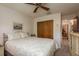 Bedroom with a patterned bedspread, ceiling fan and closet with bi-fold doors at 3388 Tarpon Woods Blvd, Palm Harbor, FL 34685