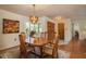 Charming dining area with a chandelier, wood table, and access to the living room at 3388 Tarpon Woods Blvd, Palm Harbor, FL 34685
