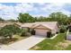 Charming single-story home with a two-car garage, a well-manicured lawn, and mature landscaping at 3388 Tarpon Woods Blvd, Palm Harbor, FL 34685