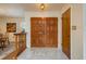 Elegant foyer with marble tile flooring and paneled wood double doors at 3388 Tarpon Woods Blvd, Palm Harbor, FL 34685