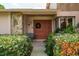 Inviting front entrance with double doors, stone accents, and lush greenery at 3388 Tarpon Woods Blvd, Palm Harbor, FL 34685