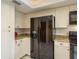 A well-maintained kitchen features a large refrigerator and ample cabinet space at 3388 Tarpon Woods Blvd, Palm Harbor, FL 34685