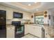 Well-lit kitchen boasts granite countertops and modern appliances for everyday functionality at 3388 Tarpon Woods Blvd, Palm Harbor, FL 34685