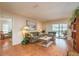 Cozy living room with wood flooring, a sliding glass door, and comfortable furnishings at 3388 Tarpon Woods Blvd, Palm Harbor, FL 34685