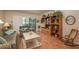 Bright living room featuring a built-in bookcase and a sliding door to the outdoor patio at 3388 Tarpon Woods Blvd, Palm Harbor, FL 34685