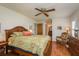 Spacious bedroom with hardwood floors, fan, and large bed with floral patterned cover at 3388 Tarpon Woods Blvd, Palm Harbor, FL 34685