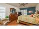 A serene main bedroom with comfortable furnishings, ceiling fan, and shuttered windows at 3388 Tarpon Woods Blvd, Palm Harbor, FL 34685