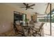 Outdoor patio with ceiling fans and a glass-top table with four cushioned chairs at 3388 Tarpon Woods Blvd, Palm Harbor, FL 34685