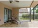 Outdoor patio area with a ceiling fan, lounge chair and view of the fenced yard at 3388 Tarpon Woods Blvd, Palm Harbor, FL 34685
