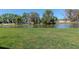 Lush green backyard overlooking a tranquil pond, perfect for relaxation and outdoor enjoyment at 34355 Sorrel Mint Dr, Wesley Chapel, FL 33543