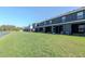 Back exterior view showing the screened-in patios and lush green backyard at 34355 Sorrel Mint Dr, Wesley Chapel, FL 33543