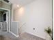 Upstairs hallway featuring soft carpet and stairway leading to the first floor at 34355 Sorrel Mint Dr, Wesley Chapel, FL 33543