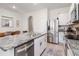 Bright kitchen with stainless steel appliances, granite countertops, and kitchen island at 34355 Sorrel Mint Dr, Wesley Chapel, FL 33543
