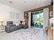Comfortable living room with a large sofa, area rug and sliding glass doors at 34355 Sorrel Mint Dr, Wesley Chapel, FL 33543