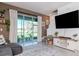 Living area with view of the outdoor patio with decorative plants and water view at 34355 Sorrel Mint Dr, Wesley Chapel, FL 33543