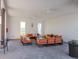 Bright lounge area featuring comfortable seating, ceiling fans, and ample natural light for relaxation at 34355 Sorrel Mint Dr, Wesley Chapel, FL 33543