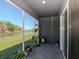 Screened patio with beautiful lake views and potted plants; ideal for relaxation at 34355 Sorrel Mint Dr, Wesley Chapel, FL 33543
