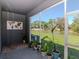 Screened patio featuring a lake view, potted plants, concrete flooring, and cool gray walls at 34355 Sorrel Mint Dr, Wesley Chapel, FL 33543