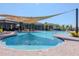 Large community pool with lounge chairs and shaded pergola at 34355 Sorrel Mint Dr, Wesley Chapel, FL 33543